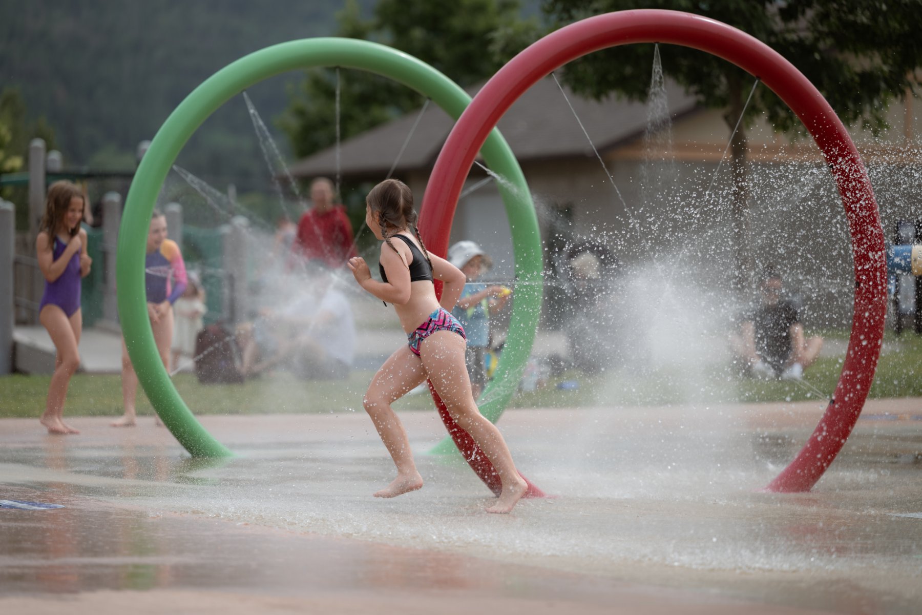Children running through the spray-park rings at Blackburn Park