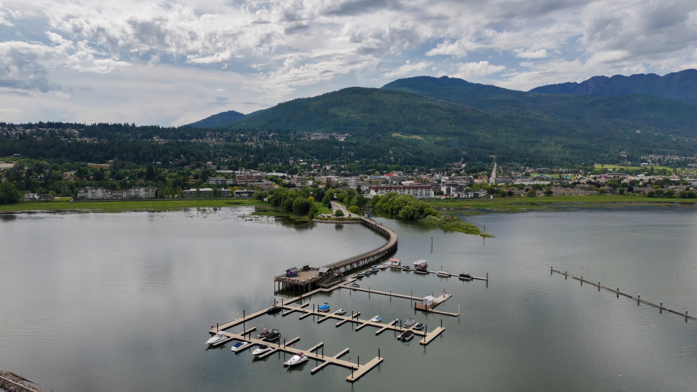 Aerial view of Marine Peace Park, the marina, and the curved wooden wharf on Shuswap Lake