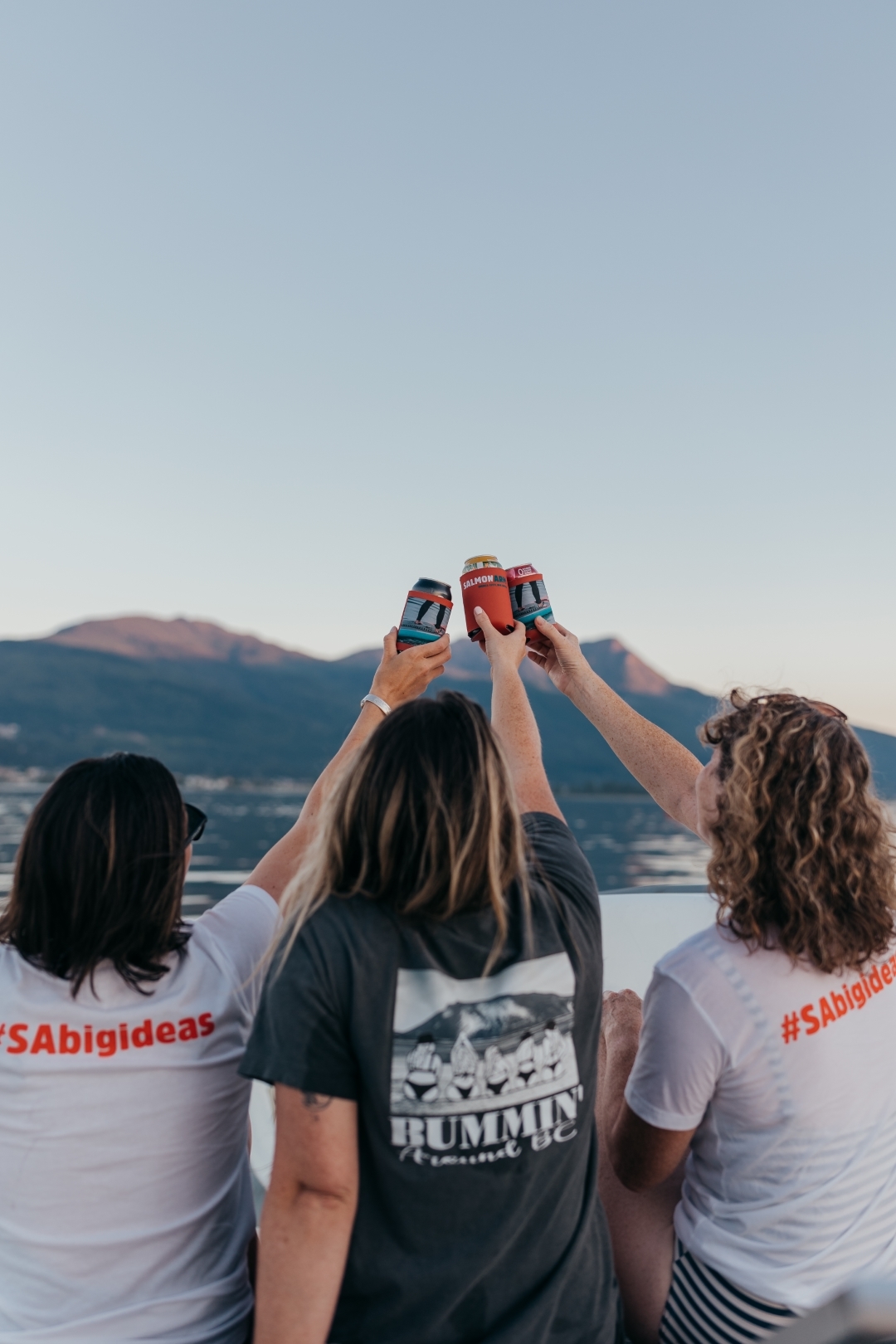 Friends raising a toast on the water on Shuswap Lake